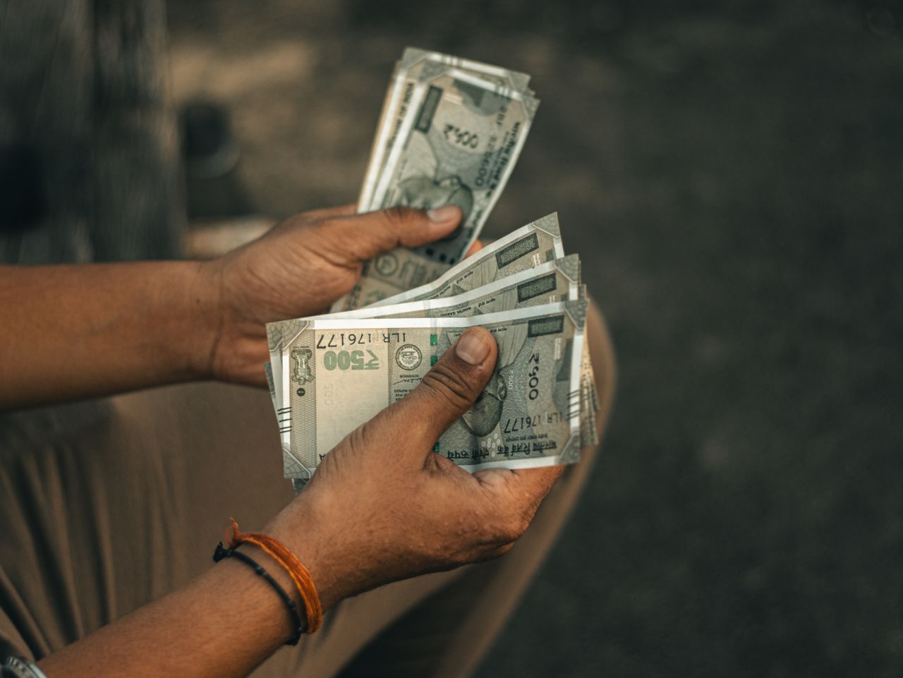 Indian rupee notes held in a hand